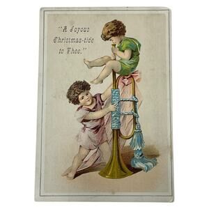 Antique Joyous Christmastide Greeting Victorian Cherubs Playing‎ Horn Ephemera
